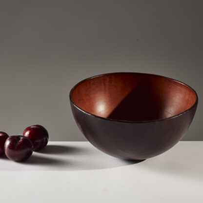 leather bowl and plums